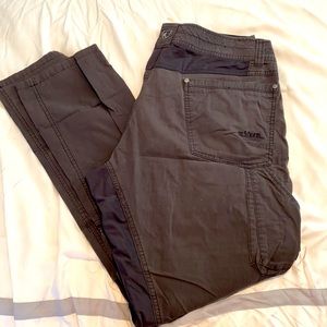 Gray colored kuhl pants that are slightly worn.
